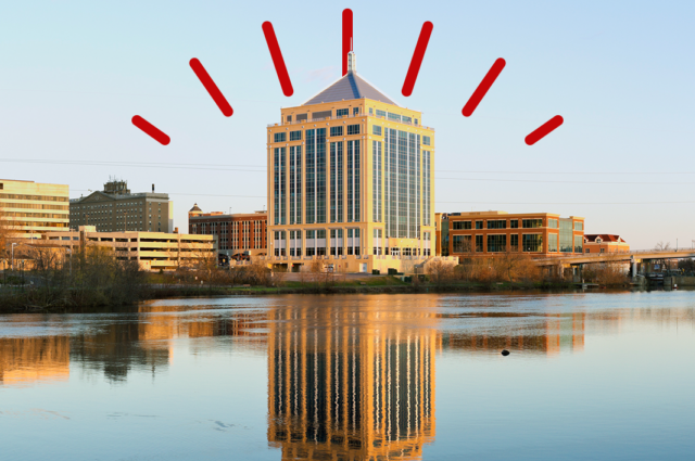 City of Wausau skyline reflected over body of water.